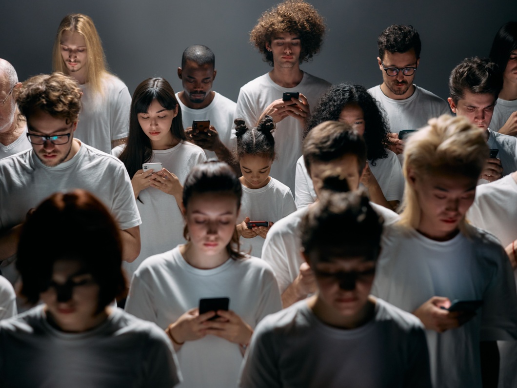 A group of people staring at their phone screens